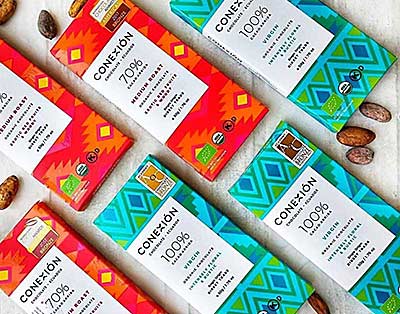several Conexión Chocolate bars and cacao beans
